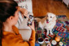 woman taking photos of her dog